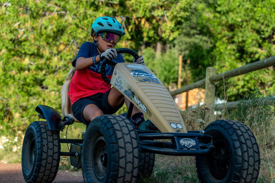 Child driving a pedal car