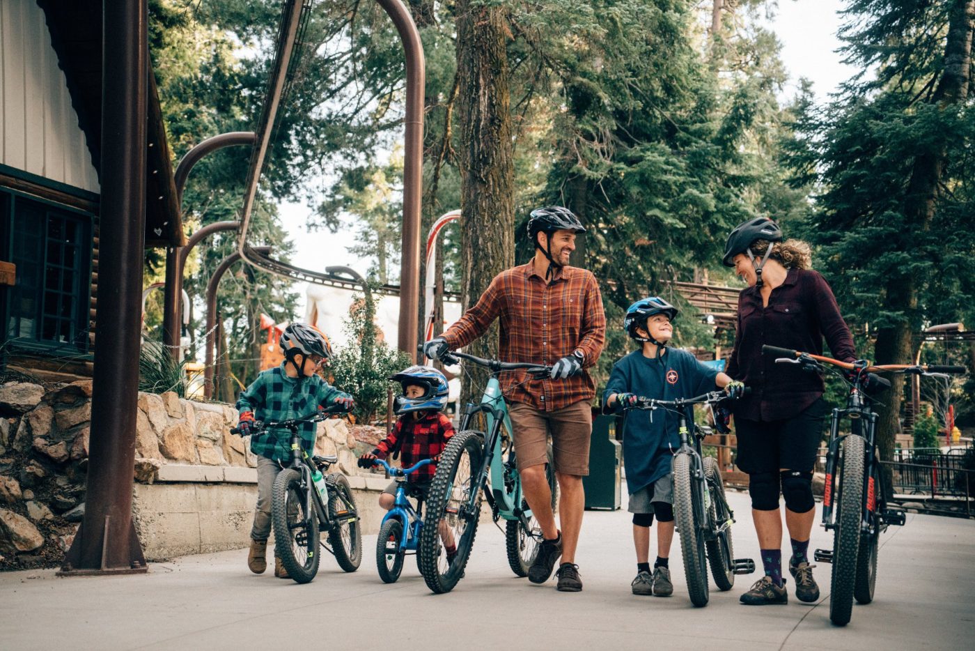 A family walking their bikes through the village